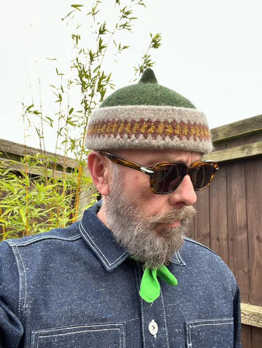 Orange patterned edge and green top woollen hat