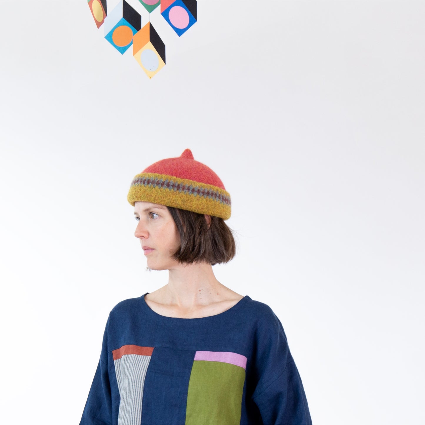 Mustard yellow patterned edge and red top woollen hat