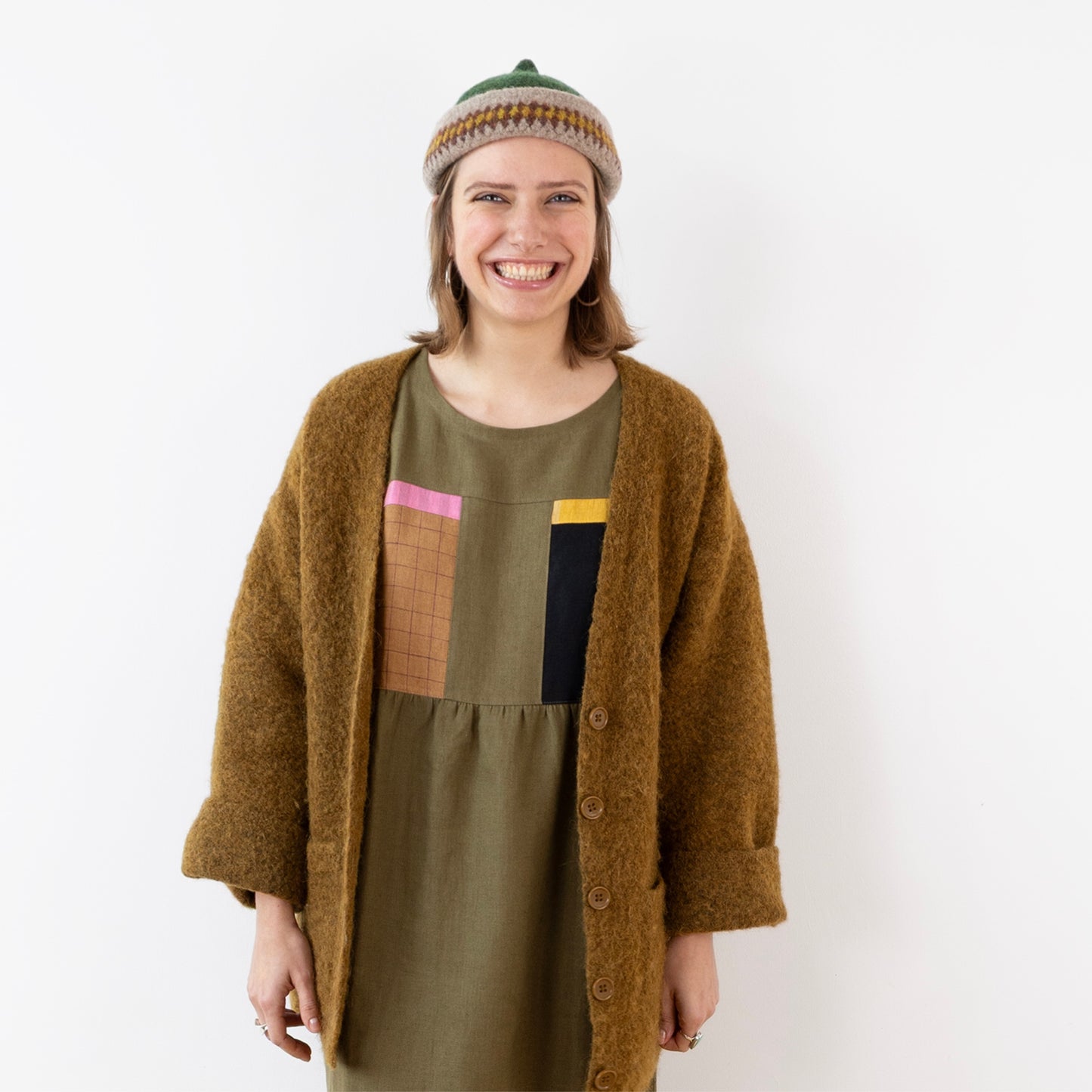 Orange patterned edge and green top woollen hat